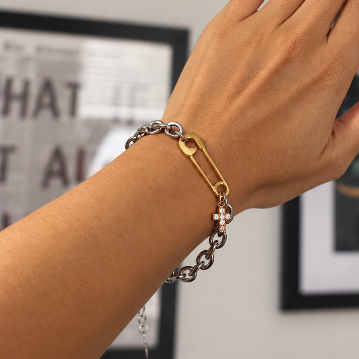 Maya Bracelet, two-tone silver chain with gold safety pin and cross charm, worn on the wrist