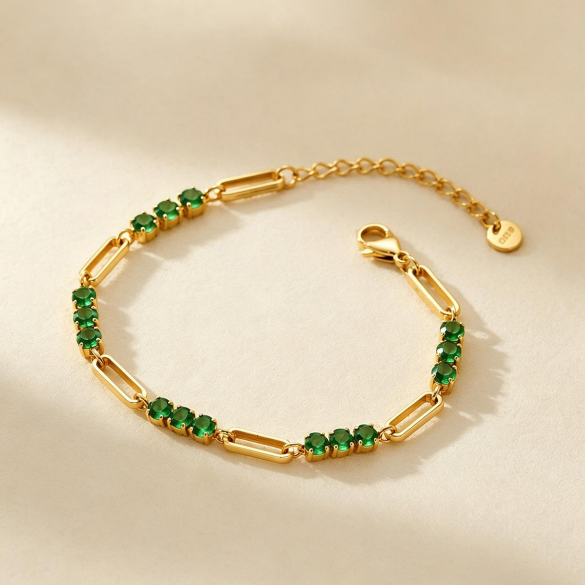 Clara Bracelet, gold paperclip links with emerald-green stones and extender chain
